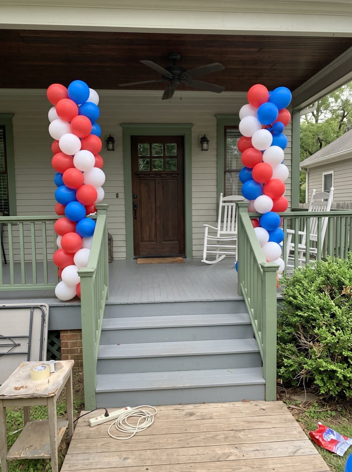 Red, white and blue spiral balloon columns on a front porch