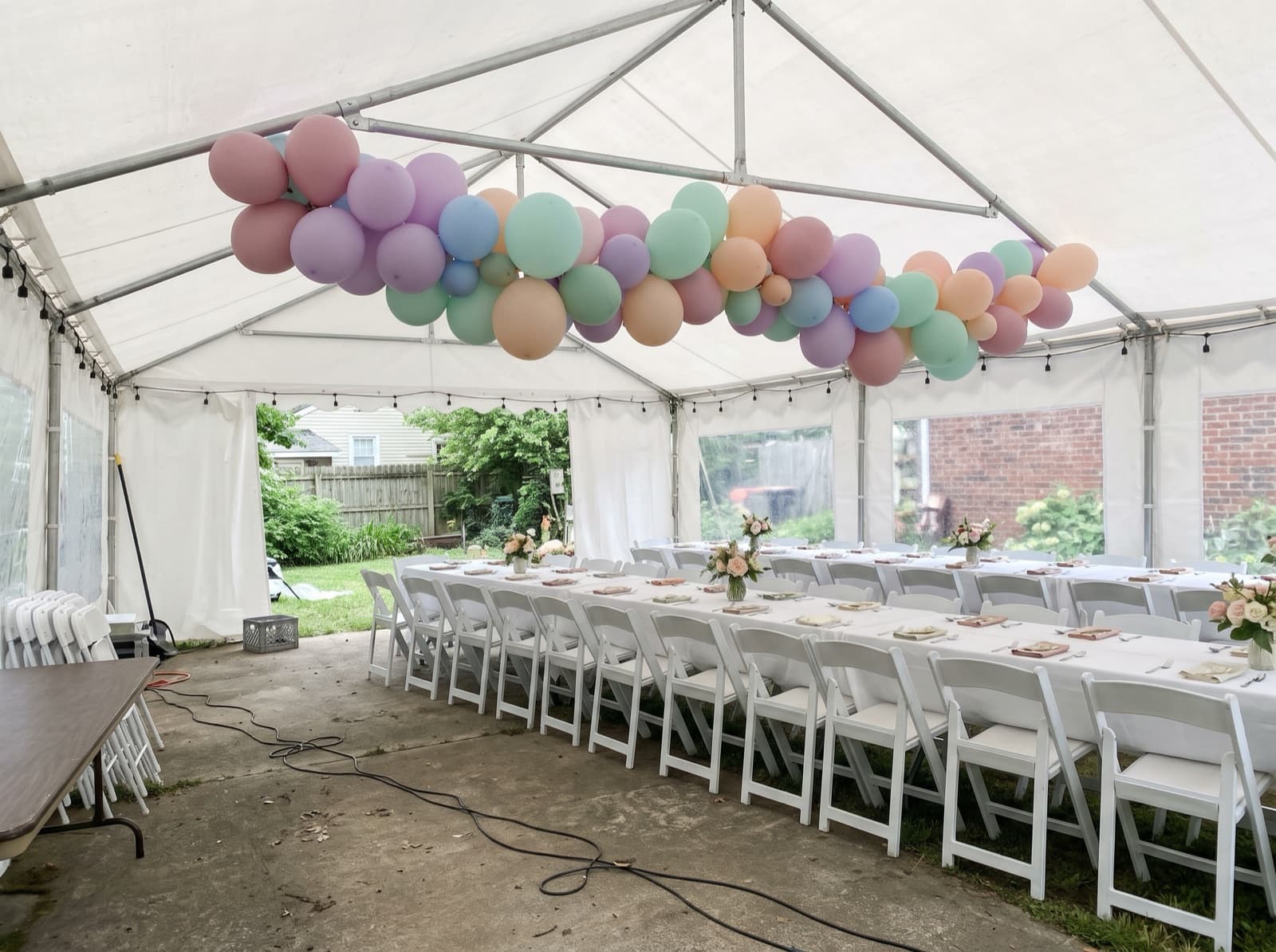 Hanging balloon garland canopy under a backyard tent