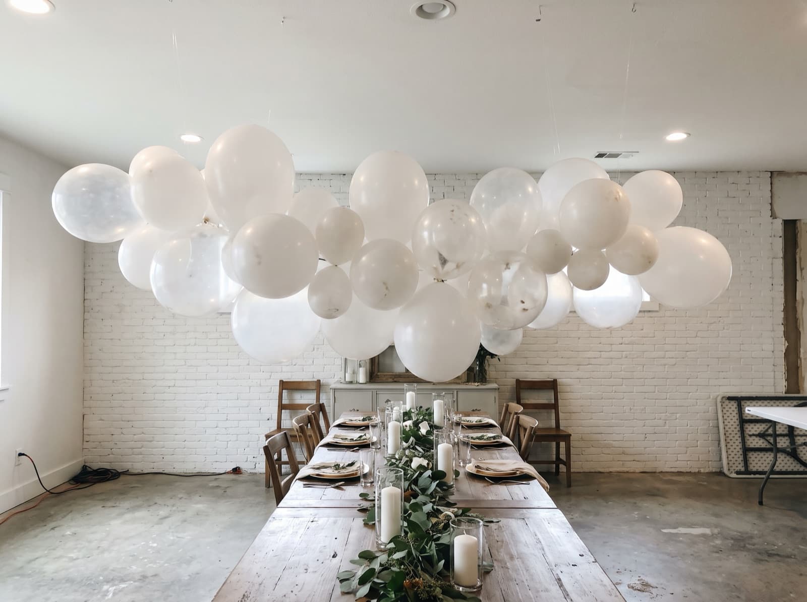 Balloon cloud over a long dining table
