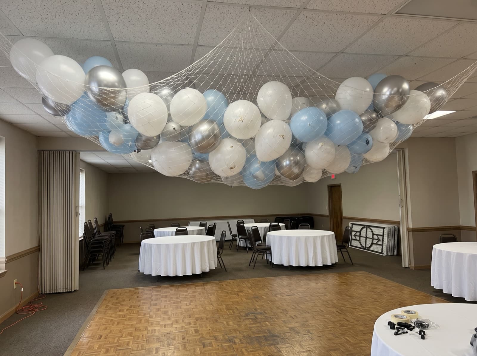 Balloon drop net overhead before a countdown