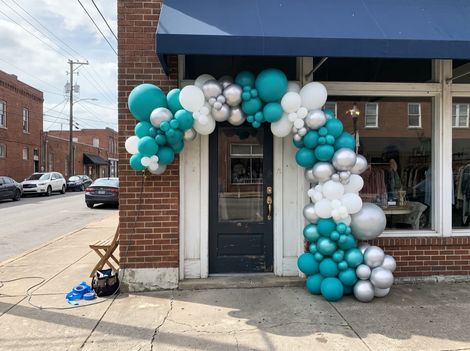 Giant organic balloon installation framing a boutique storefront