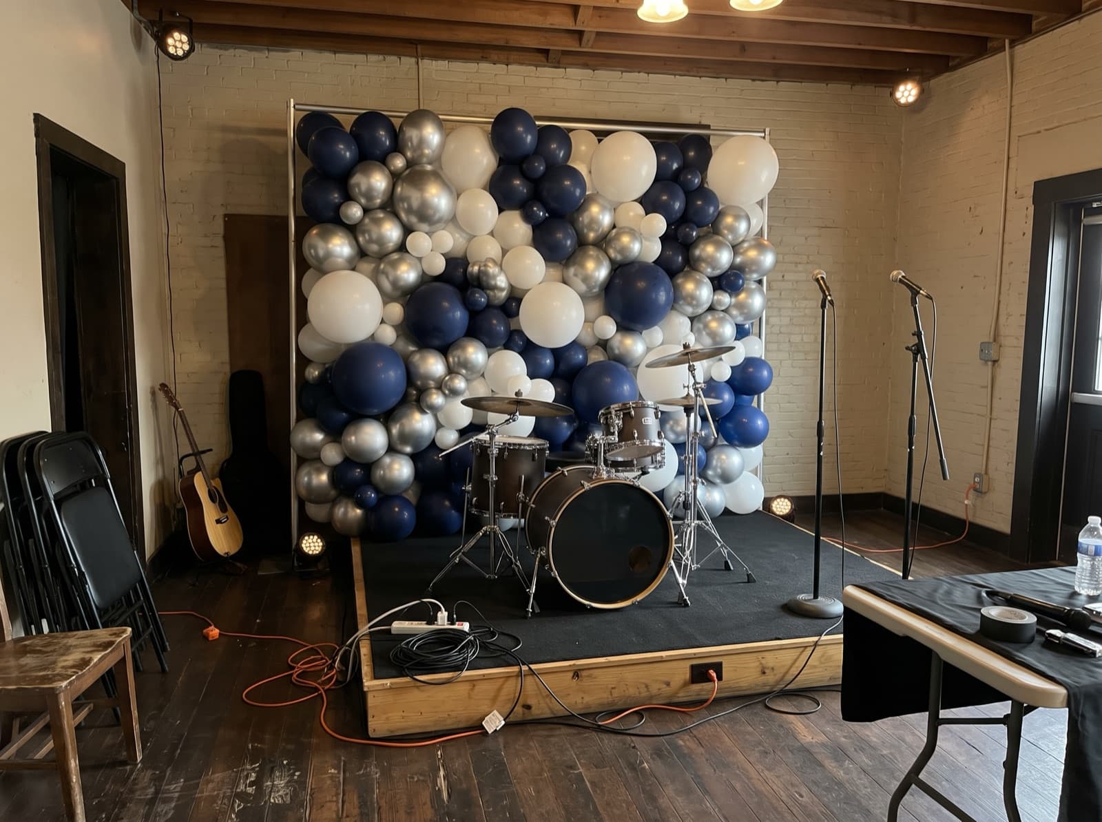 Balloon wall behind a small band stage