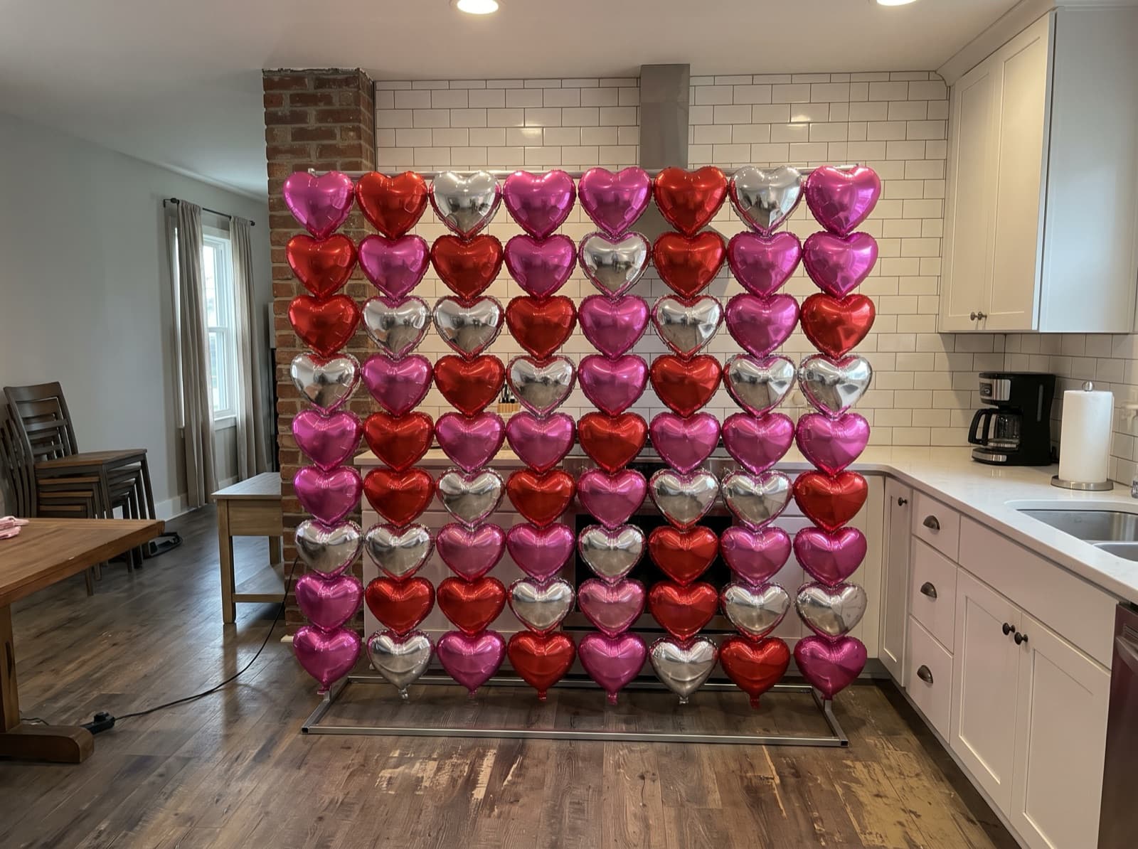Foil heart balloon wall in hot pink, red and silver
